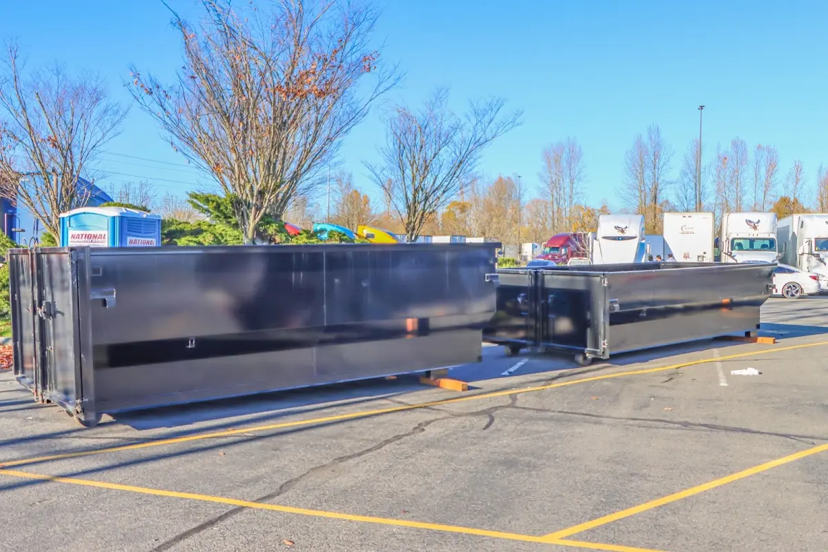 Professional dumpster rental service with roll-off container on residential driveway in Egelston